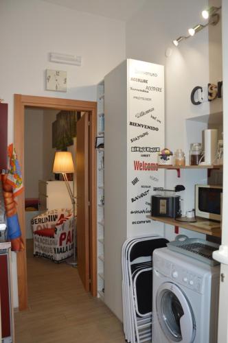 a kitchen with a washing machine and a sign on the wall at L'angoletto in Matera