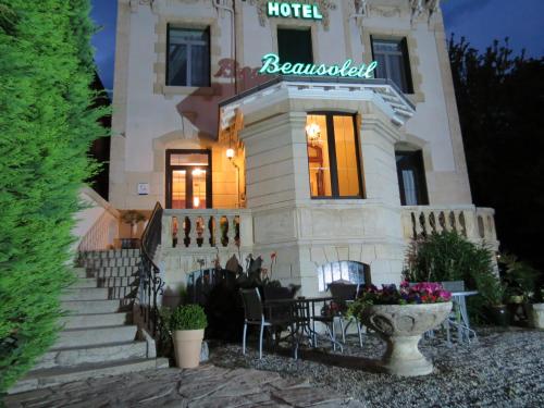 a house with a sign on the front of it at Hôtel Beausoleil in Montélimar