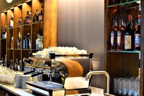 a bar with a counter with bottles of wine at Hotel Lo! im Kreuz Jona in Rapperswil-Jona