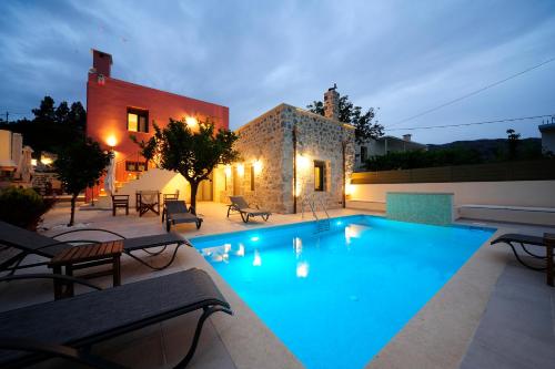 a large swimming pool in front of a house at Hawk Villa, nature essence, By ThinkVilla in Yerakárion