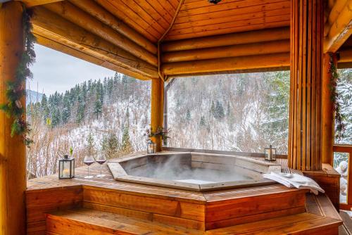 a bath tub in a room with a large window at Villa Alpiyka in Slavske
