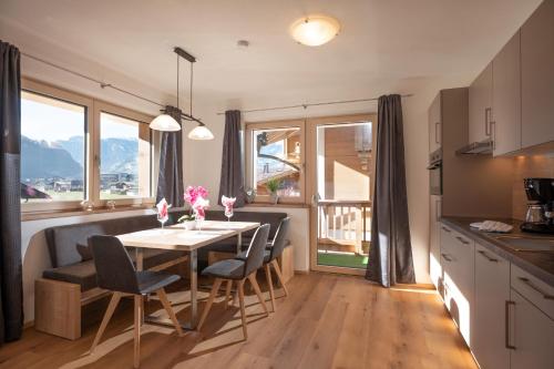 a kitchen and dining room with a table and chairs at Apart Platzer in Zell am Ziller