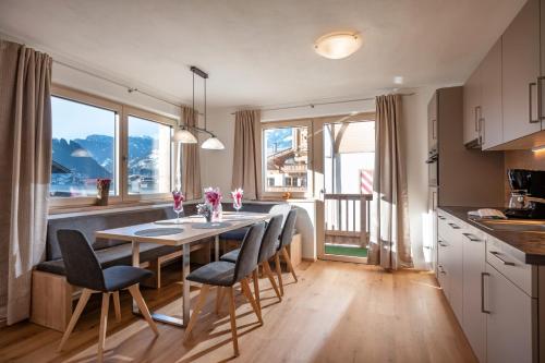 a kitchen and dining room with a table and chairs at Apart Platzer in Zell am Ziller