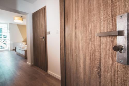 an open wooden door in a room with a hallway at Skałka Zieleniec in Duszniki Zdrój