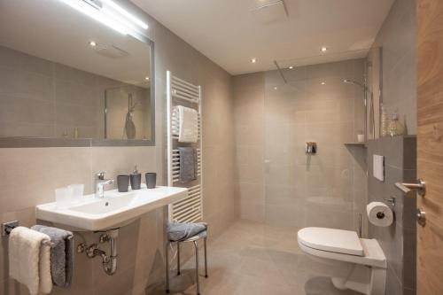 a bathroom with a sink and a toilet at Apart Platzer in Zell am Ziller