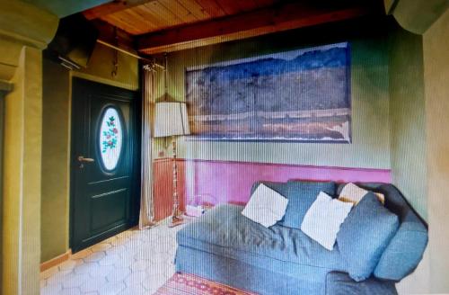 a living room with a couch and a door at Relais B in Ancona