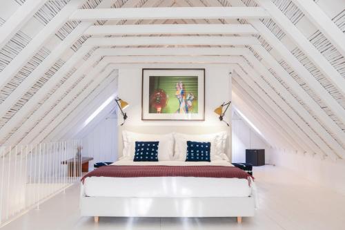 a white bedroom with a large bed in a white room at São Paulo Boutique Hotel - SPBH in Tavira