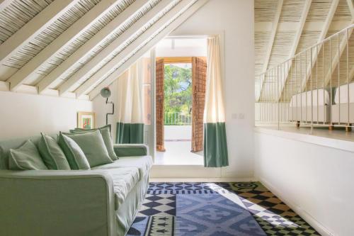 a living room with a couch and a window at São Paulo Boutique Hotel - SPBH in Tavira