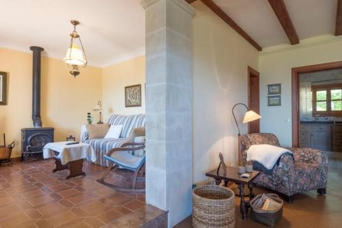 a living room with a couch and a fireplace at Casa Bonaire Esporles in Esporles