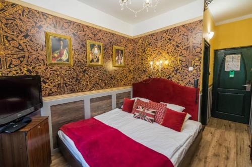 a bedroom with a bed and a tv in it at Janus Boutique Hotel & Spa in Siófok
