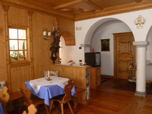 a dining room with a table and a kitchen at Cadore Haus in Auronzo di Cadore