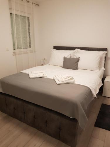 a large bed with two towels on top of it at Luxury APP Anna ( near center) in Crikvenica