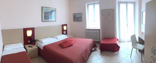 Ένα ή περισσότερα κρεβάτια σε δωμάτιο στο Albergo Riva
