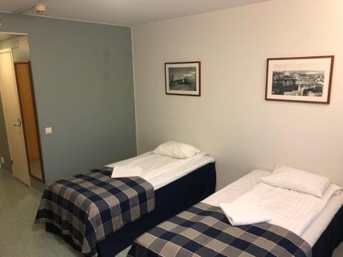 two beds in a hotel room with two at West Side Hotel in Turku