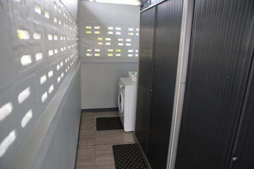 a bathroom with a toilet and a view of a building at Donfarsha Apartments in Paramaribo