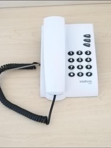 a white telephone sitting on top of a table at Hotel Costeiro in Olinda