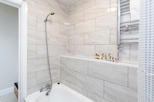 a bathroom with a shower with a bath tub at WelcomeStay Clapham Junction 2 Bedroom Apartment in London