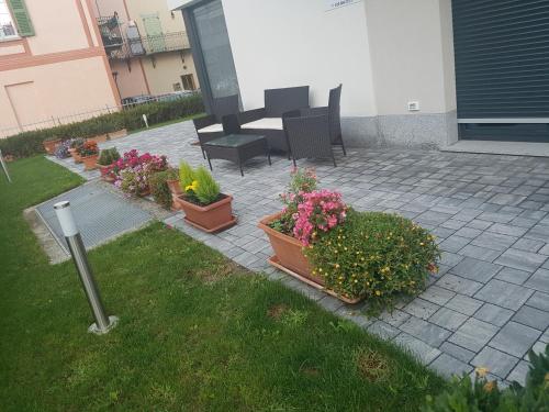 a patio with potted plants and a table and chairs at B & B Il sorriso in Tirano