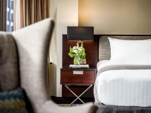 
a bed in a hotel room with a lamp on top of it at InterContinental Wellington, an IHG Hotel in Wellington
