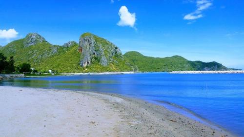 a view of a beach with mountains in the background at Yen~Yen B&B in Prachuap Khiri Khan