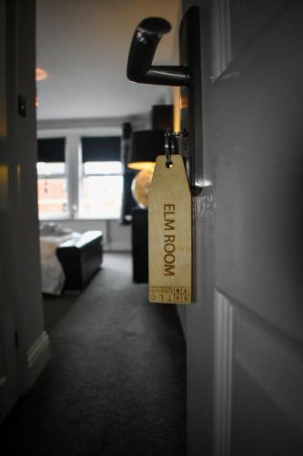 a tag on the door of a room at TLC Exmouth Bed and Breakfast in Exmouth