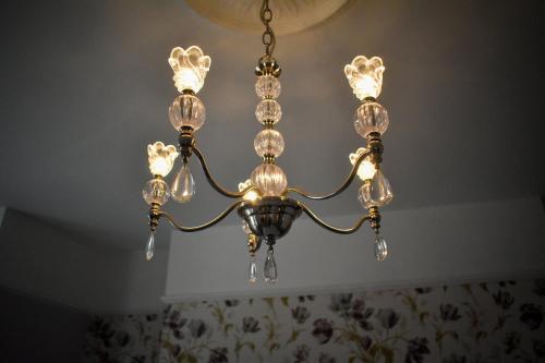 a chandelier hanging from a ceiling at TLC Exmouth Bed and Breakfast in Exmouth