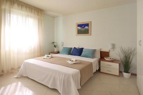 Ένα ή περισσότερα κρεβάτια σε δωμάτιο στο Residence Altamarea