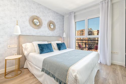 a bedroom with a large bed and a window at iloftmalaga Calle Alemania I in Málaga