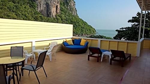 a patio with chairs and a couch and a table at Yen~Yen B&B in Prachuap Khiri Khan