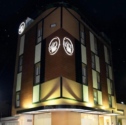 a building with two clocks on the side of it at Hotel Mio Boutique in Cúcuta