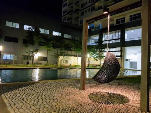 a sculpture sitting in front of a building at night at Puchong Skypod Residence, 1-5 pax with Balcony Unit, Walking Distance to IOI Mall, 10min Drive to Sunway in Puchong