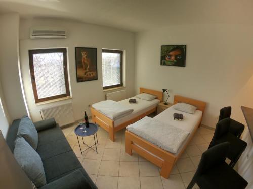 a living room with two beds and a couch at Apartment Ivan-Experience 2 Bedrooms in Ljubuški