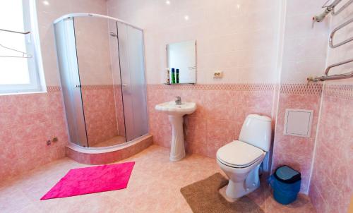 a bathroom with a toilet and a shower and a sink at Guest House Gostevie Domiki in Goryachiy Klyuch