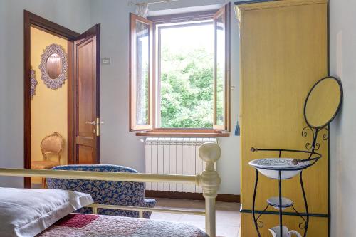 a bedroom with a bed and a window at Garden House in Montepulciano