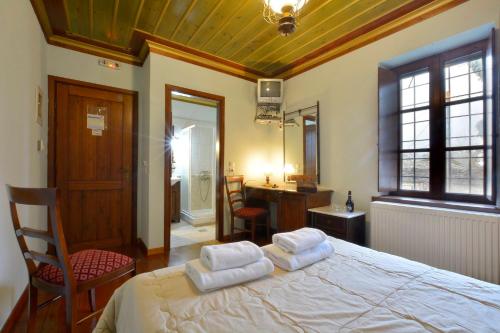 a bedroom with a large bed with two pillows on it at Nikolas Guesthouse in Koukouli