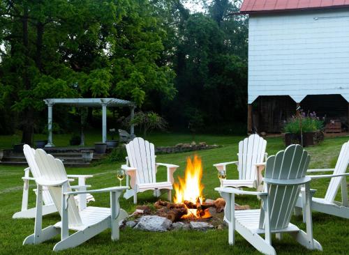 a group of chairs around a fire in a yard at South Court Inn in Luray