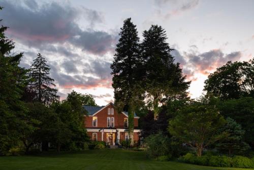 a large house with trees in front of it at South Court Inn in Luray