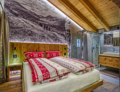 a bedroom with a bed and a shower and a sink at Le Chalet Luxury Apartment in Livigno