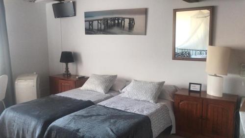a bedroom with a bed and a lamp at Casa de Huespedes la Peña in Ibiza Town