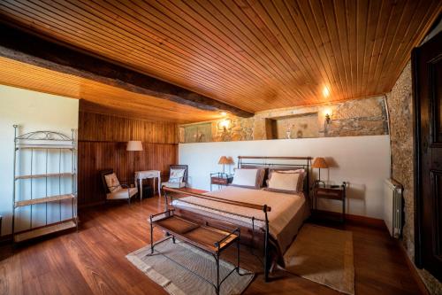 ein Schlafzimmer mit einem Bett und einer Holzdecke in der Unterkunft Casa de Sta Comba in Barcelos
