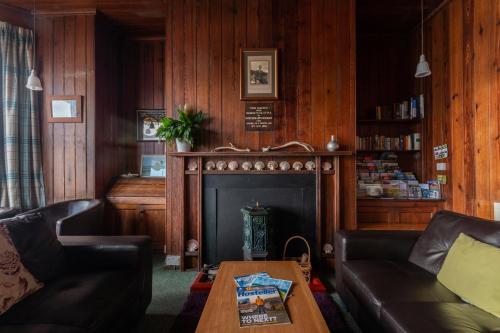 a living room with a couch and a fireplace at Gairloch Sands Youth Hostel in Gairloch