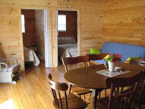a room with a table and chairs and a bedroom at Princehaven Campground in Princeton