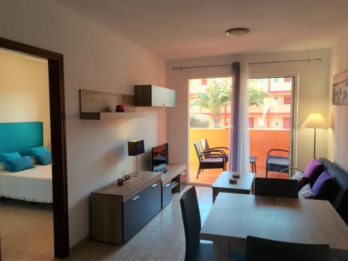 a living room with a bed and a dining room at Casa Mar y Dunas in Parque Holandes