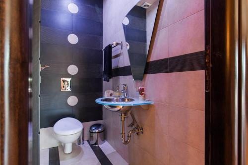 a small bathroom with a toilet and a sink at Unique Villa Melia Lagonisi in Kalívia Thorikoú