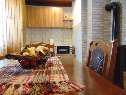 a table with a basket of fruit on top of it at Vikendica Sekulić in Bajina Bašta