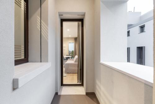 a hallway of a house with white walls and a window at JOIVY Treviso Vittoria in Treviso