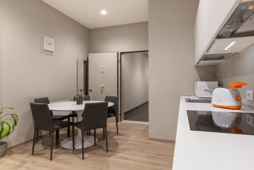 a kitchen and dining room with a table and chairs at JOIVY Treviso Vittoria in Treviso