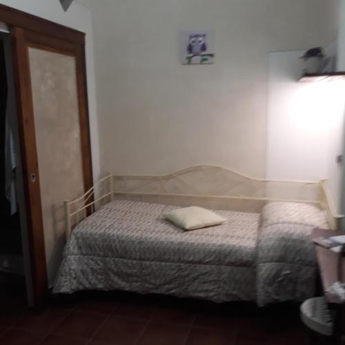 a small bedroom with a bed with a towel on it at B&B Borgo Cortese in Gavi