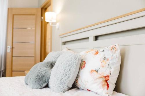 a bed with two pillows on top of it at Brand-New Deluxe Apartment in Liepāja in Liepāja