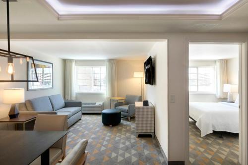 ein Hotelzimmer mit einem Bett und einem Wohnzimmer in der Unterkunft Holiday Inn - Bloomington W MSP Airport Area, an IHG Hotel in Bloomington